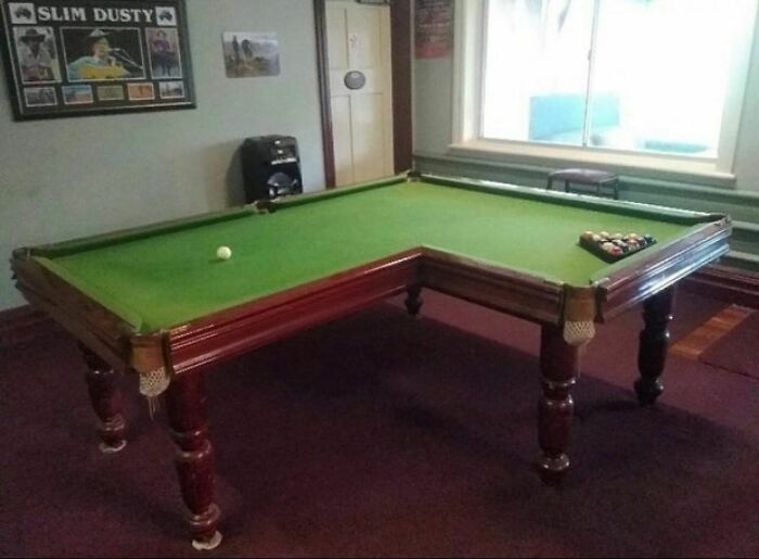 Unusual corner design on a pool table in a dimly lit room for fans of random and cringe photos humor.