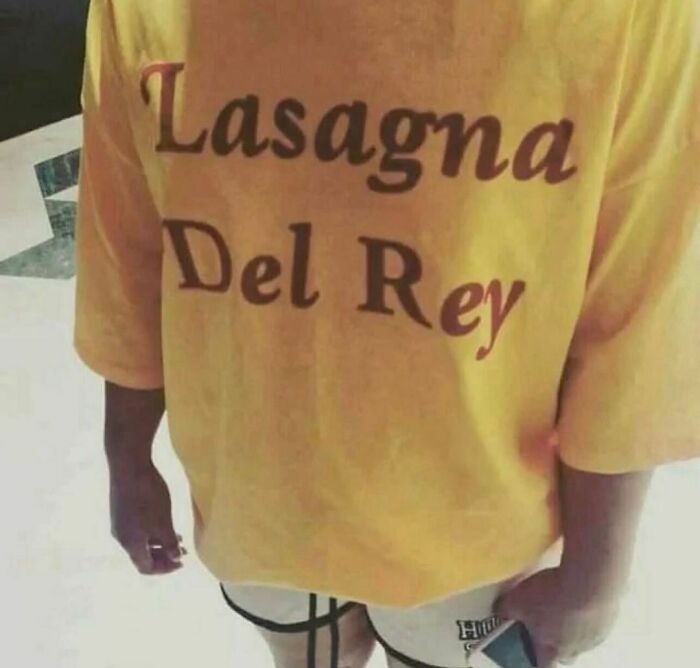 Person wearing a yellow shirt with a funny "Lasagna Del Rey" print, showing random and cringe humor style.