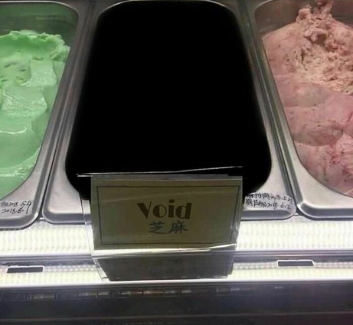 Black ice cream labeled void between two other scoops, showcasing a random and cringe moment for unique humor fans.