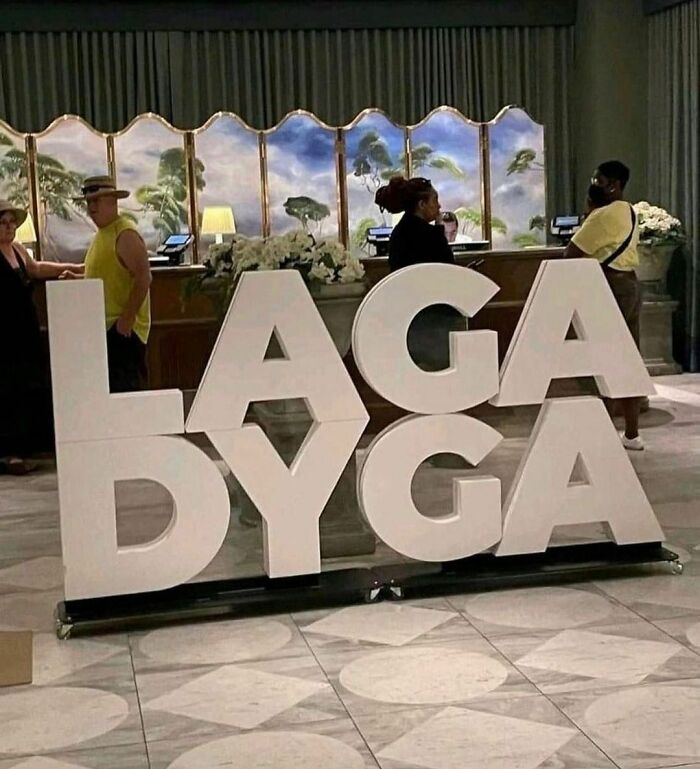 Large white letters "LAGA DYGA" displayed in a hotel lobby as part of a weird Instagram account showcase.