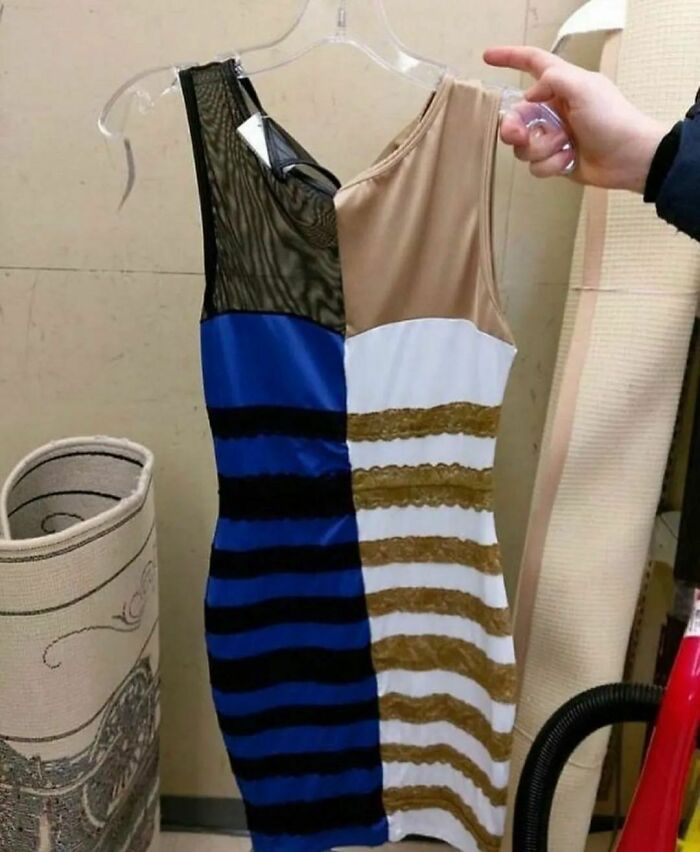 Two-toned dress with blue-black and white-gold sections on a hanger, featured on a weird Instagram account.