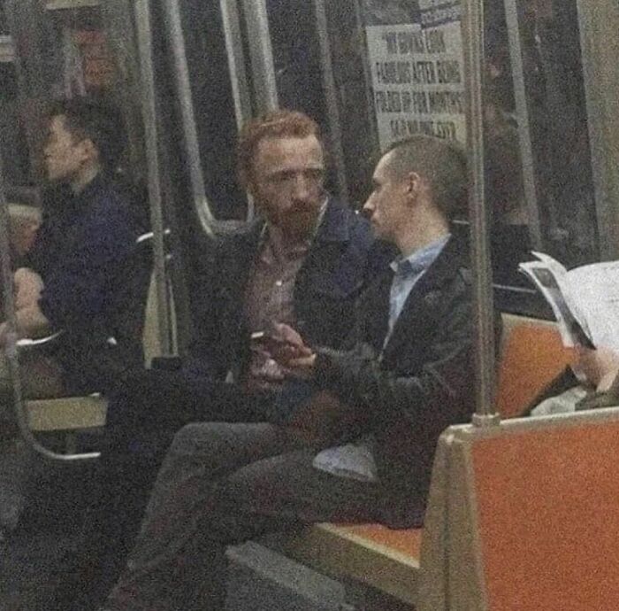 Two men having a conversation on a subway train, fitting the quirky vibe of the weirdest Instagram account.