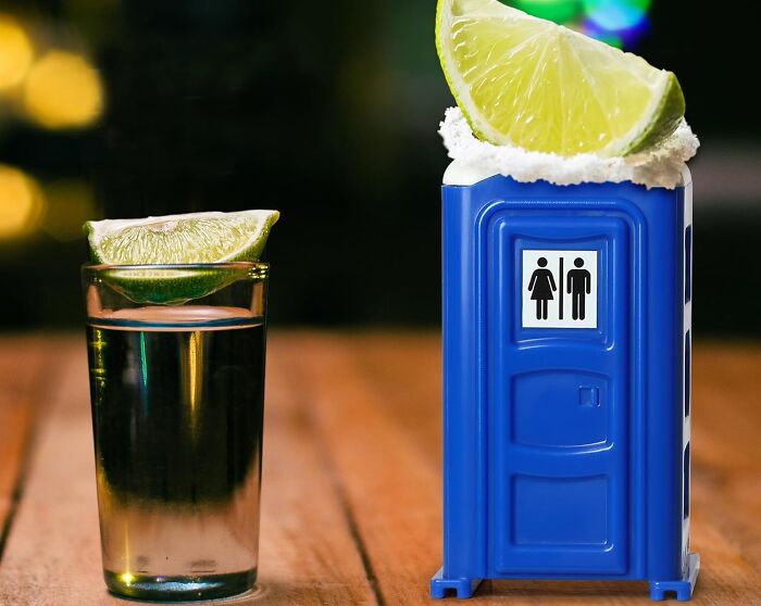 Unusual shot glass shaped like a portable toilet with a lime wedge on top.