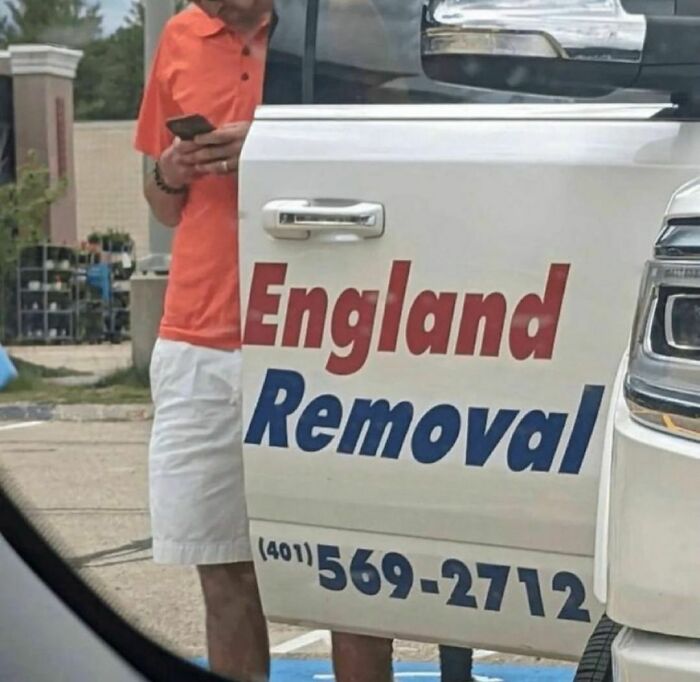Man in orange shirt stands behind a truck door with awkwardly spaced England Removal sign and phone number visible.