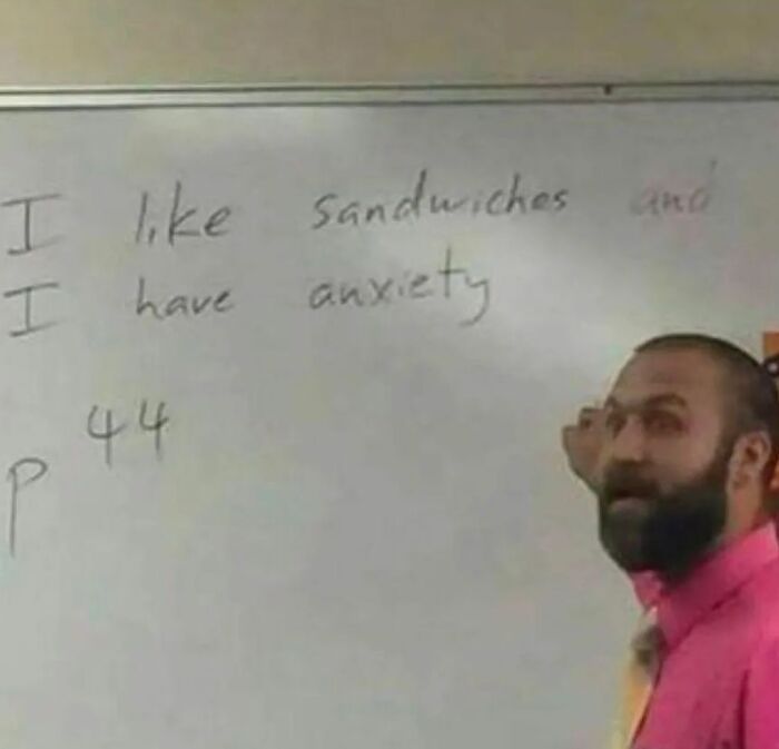 Man in bright pink shirt writing awkward message on whiteboard about sandwiches and anxiety in awkward photos collection