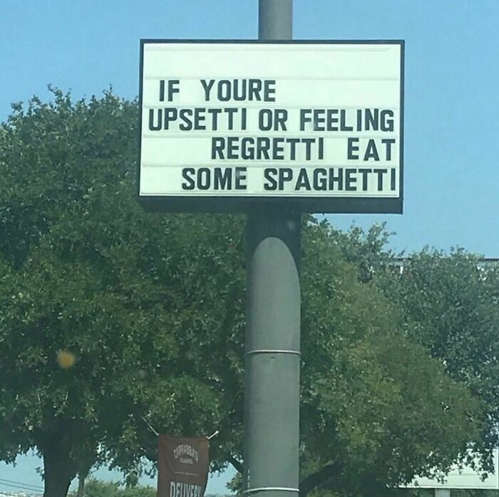 Sign with awkward spelling error says if you're upsetti or feeling regretti eat some spaghetti, awkward photos humor.