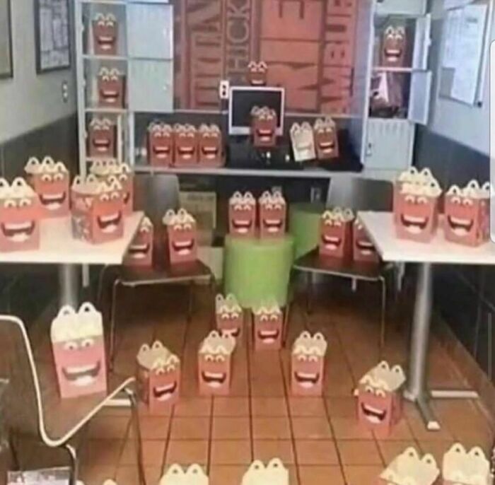 Multiple fast food happy meal boxes arranged in a room creating an awkward photos scene almost too painful to look at