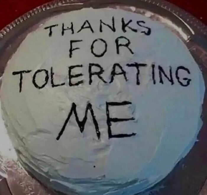 Cake with awkwardly written text saying thanks for tolerating me, fitting awkward photos theme and humor.