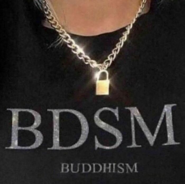 Close-up of a person wearing a B**M necklace and a shirt with awkward text mix-up between B**M and Buddhism.