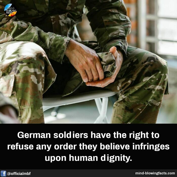 Soldier in camouflage uniform sitting and holding a fabric with amazing facts about human dignity rights.