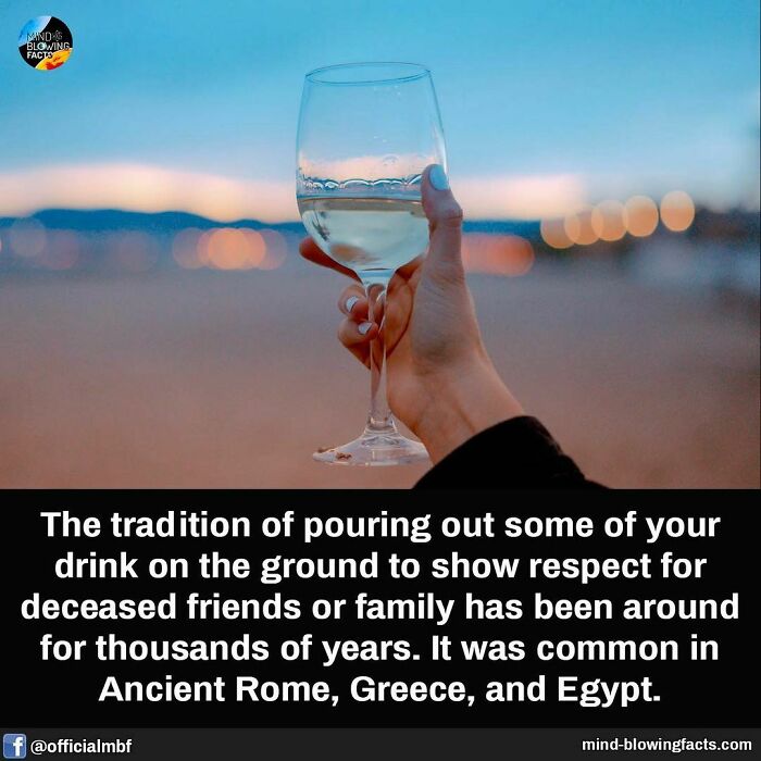 Hand holding a wine glass with liquid, illustrating an amazing fact about ancient drink-pouring traditions for respect.