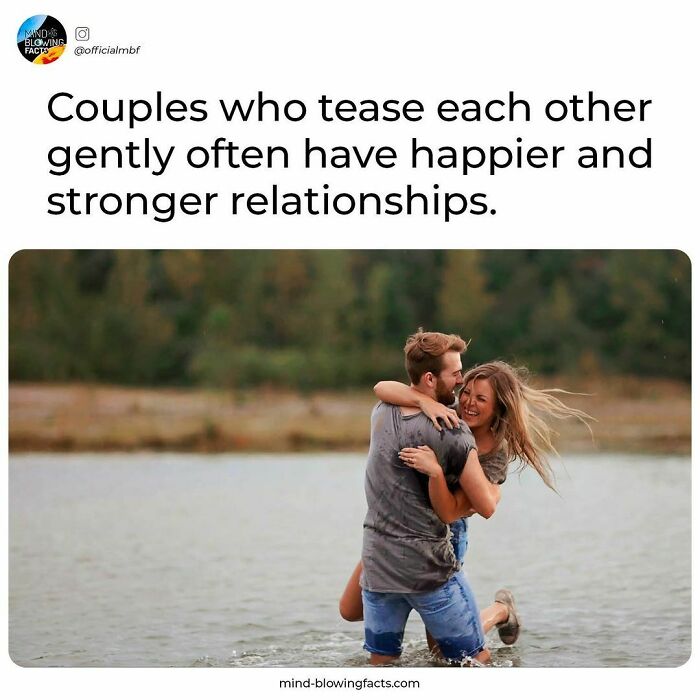 Couple smiling and hugging playfully in water with nature background, illustrating amazing facts about happy relationships.