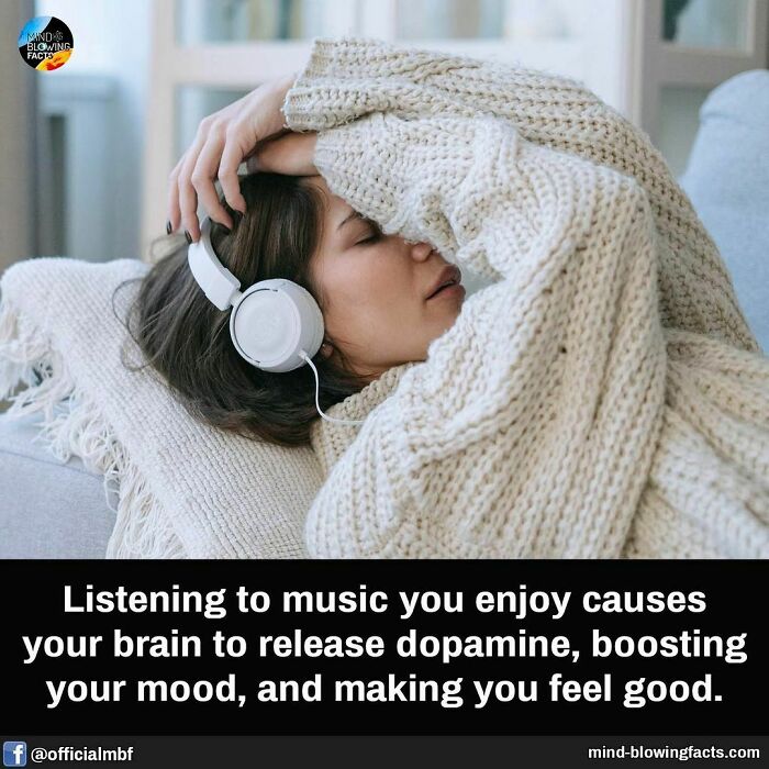 Woman in cozy sweater listening to music with headphones, illustrating mind-blowing facts about mood and dopamine release.