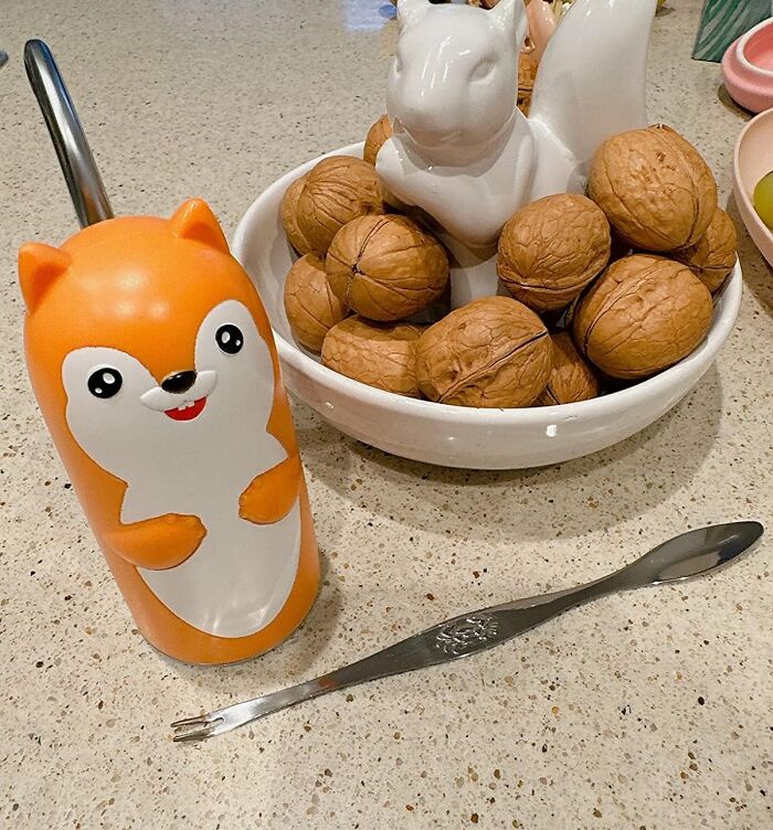 Cute nutcracker tool shaped like an animal and a bowl of walnuts, unique genius Amazon finds for problem-solving.