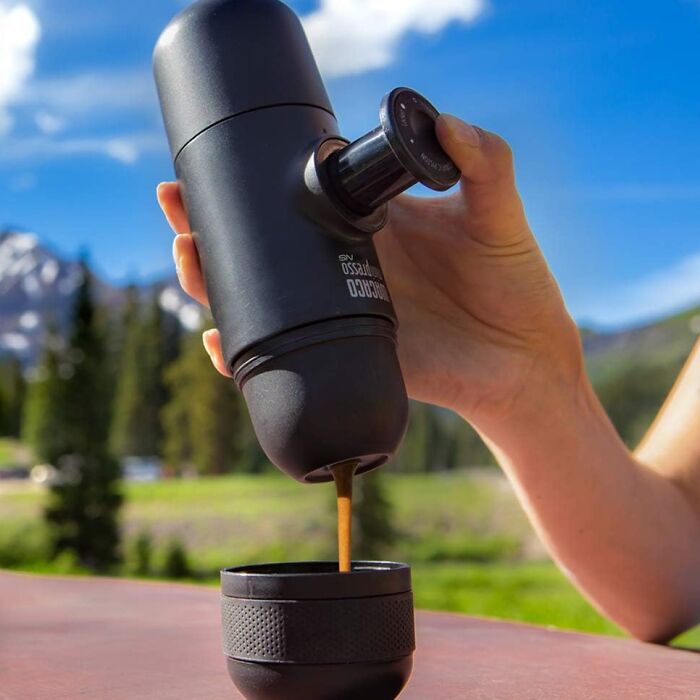 Portable espresso maker pouring coffee into a cup outdoors, one of the genius Amazon finds solving everyday problems.