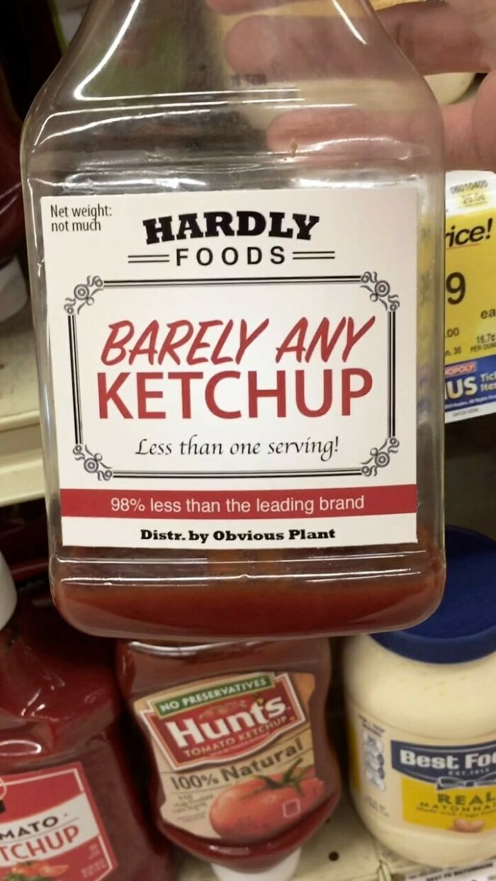 Fake product "Barely Any Ketchup" by Obvious Plant on a store shelf among real condiments.