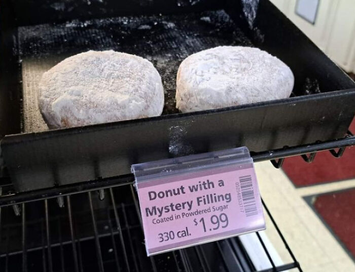 Donuts with mystery filling in a display case; labeled $1.99 each and 330 calories.
