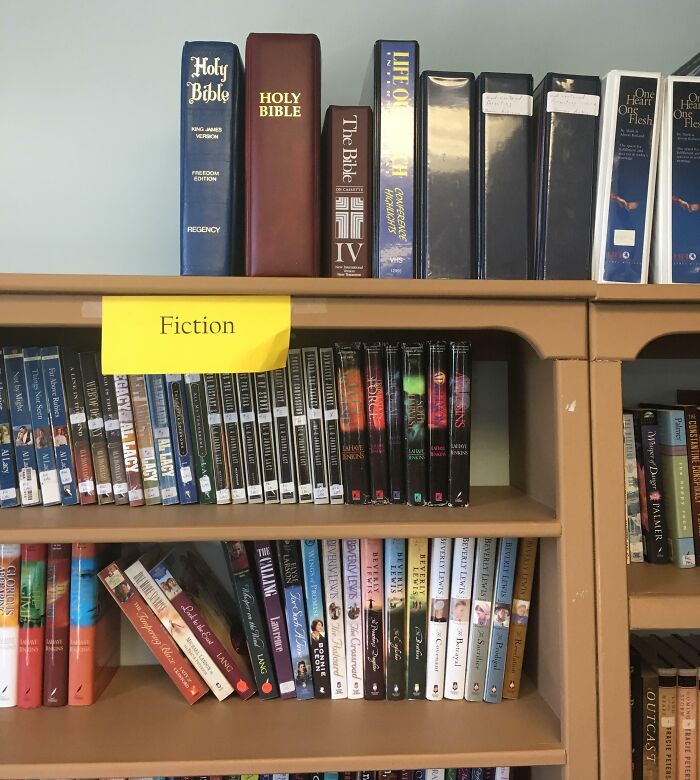 Attended A Meeting Booked At A Conference Room/Library In A Local Church, And A Coworker Noticed This Ironic Placement In Their Library