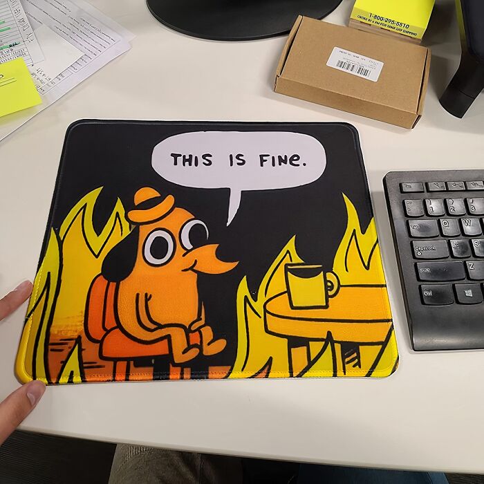 "Mouse pad with 'This is Fine' comic design, part of work supplies to improve Monday vibes."