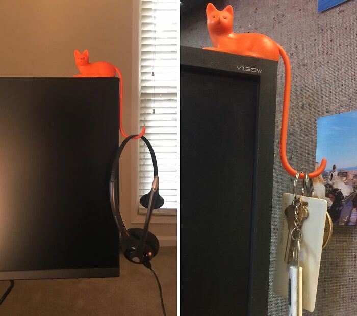 Orange cat-shaped hook holding items on a monitor, great work supplies for a personalized touch.