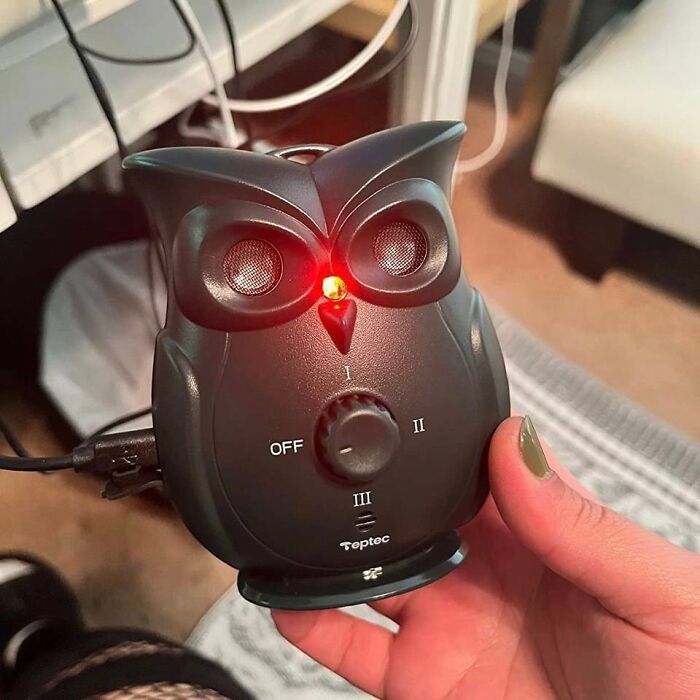 Owl-shaped pet gadget with glowing red light, used to show love to your fur-baby.