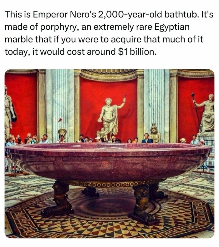 Emperor Nero’s 2,000-year-old rare marble bathtub made of porphyry shown in a historical museum with visitors looking on.