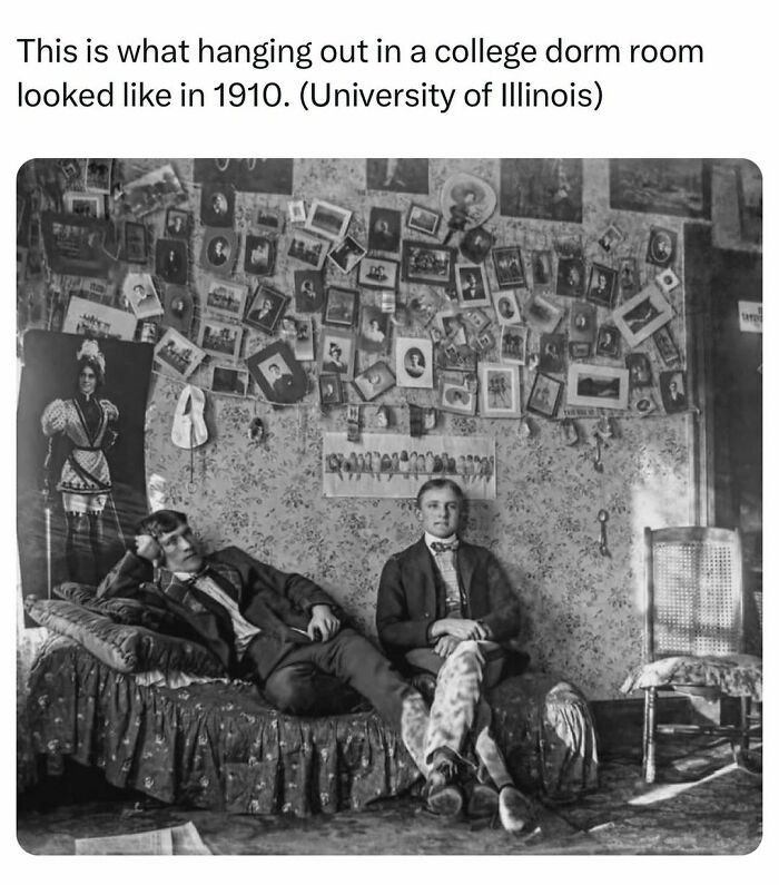 Two young men hanging out in a 1910 college dorm room filled with photos, showcasing history facts and vintage student life.