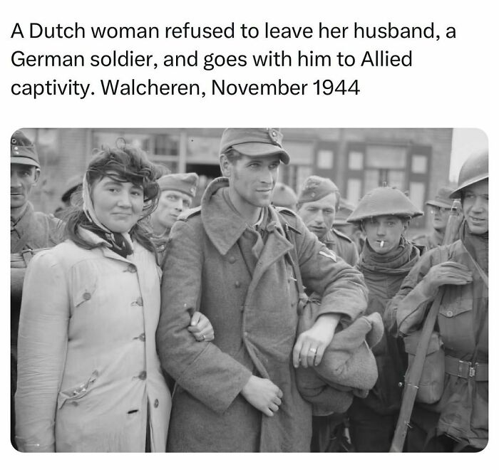 Black and white photo of a Dutch woman with German soldier and Allied soldiers in 1944, history facts moment.