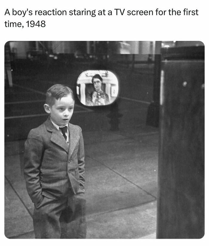 A boy's amazed reaction watching a TV screen for the first time in 1948, a popular history facts moment.