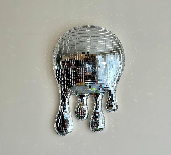 Reflective mosaic art piece shaped like melting droplets, showcasing one of the year's most amazing discoveries.