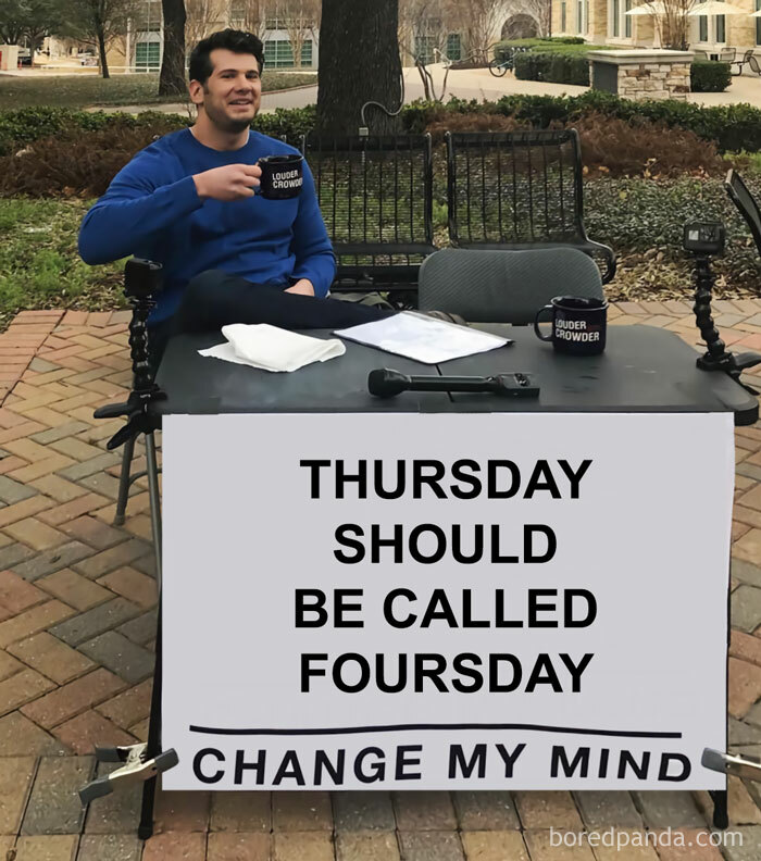 Man sitting at a table with a sign saying, "Thursday should be called Foursday," enjoying Thursday memes.