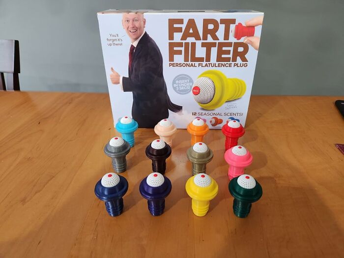 Colorful fart filters on a table with packaging in the background, showcasing weird things that actually exist.