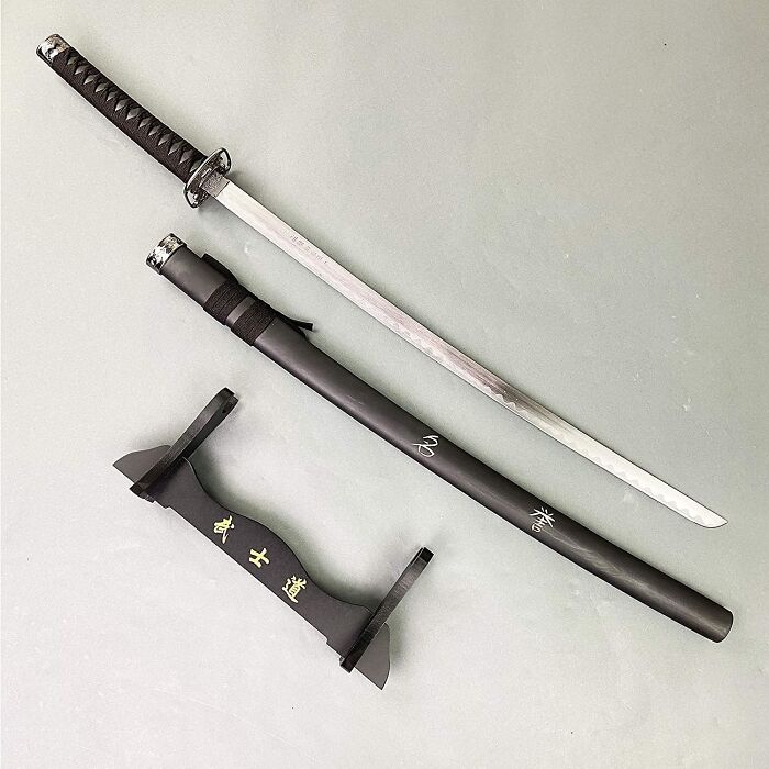 Katana sword with sheath and stand, one of the random things capturing our attention.