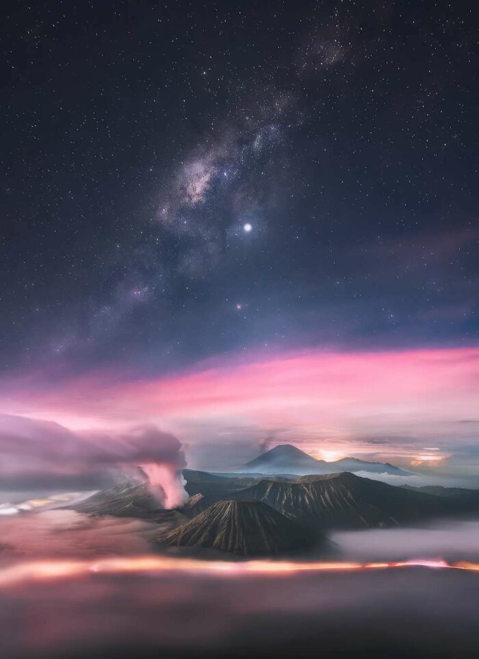 Volcanic landscape under a starry night sky with vibrant pink clouds in breathtaking landscape photos from 2024 ReFocus Awards.