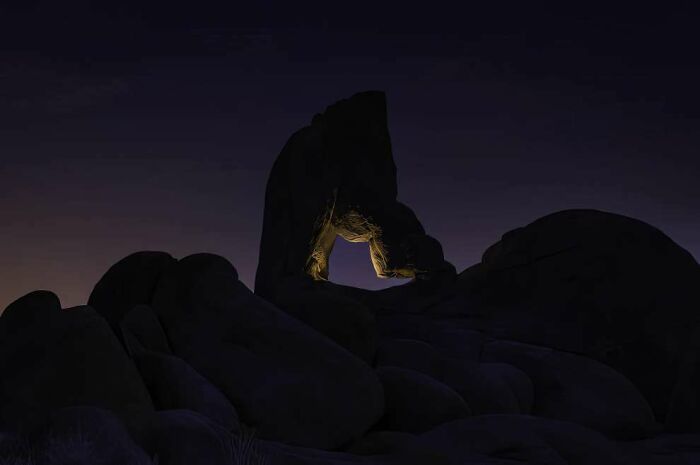 Rock formation glowing at night in a breathtaking landscape photo featured in the 2024 ReFocus Awards collection.