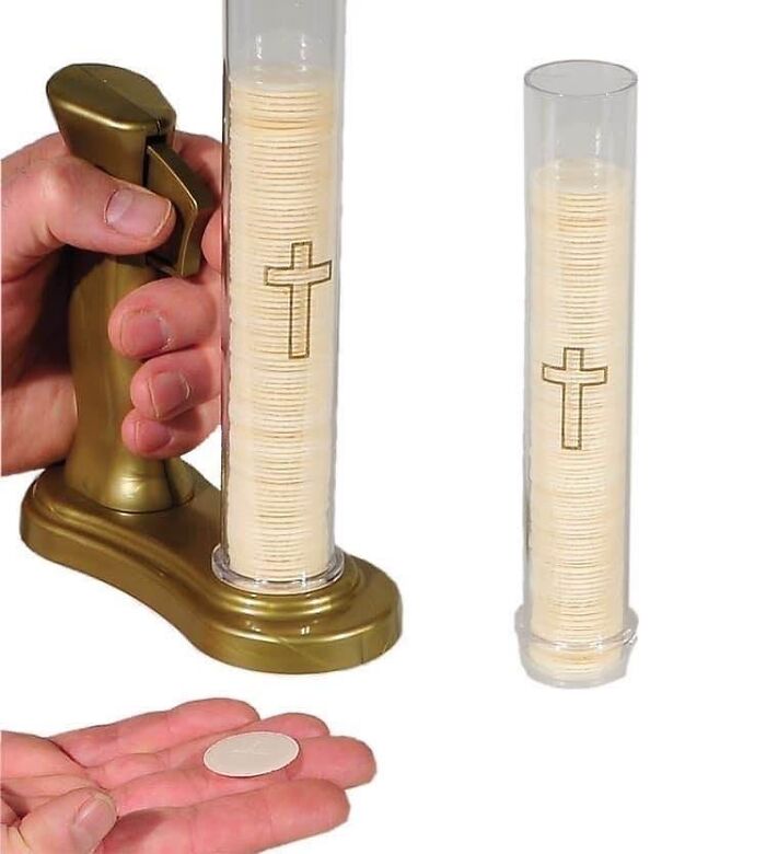 Hand pressing a gold dispenser holding a stack of communion wafers with a cross, part of cursed pics and memes collection.