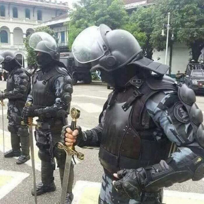 Police officers in riot gear holding swords, featured in cursed pics and memes shared on Instagram.