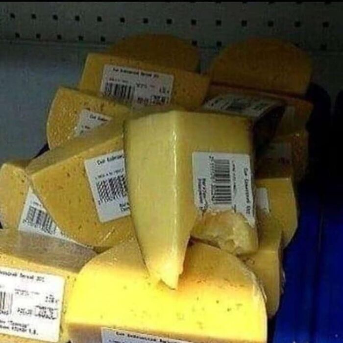 Stack of cheese wedges with labels, showing a cursed image featured on an Instagram page sharing cursed pics and memes.