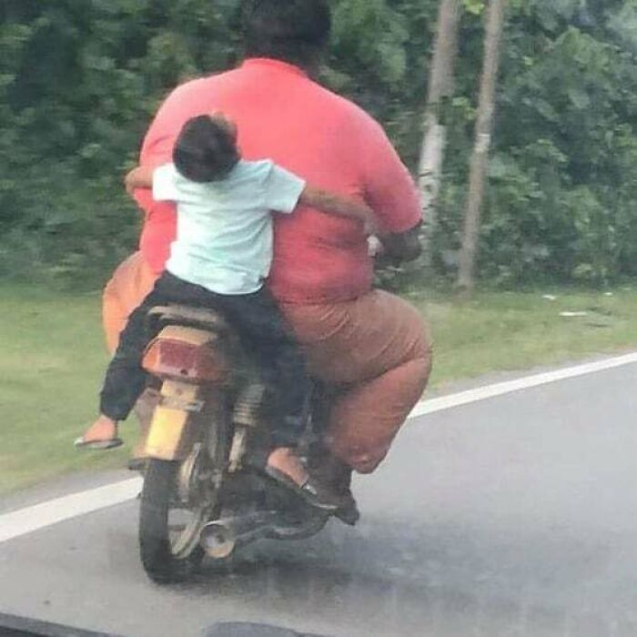 Two people riding a motorcycle with a humorous and cursed appearance, fitting cursed pics and memes on Instagram.
