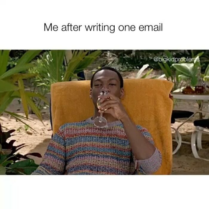 Person relaxing with a drink after writing an email, illustrating relatable humor in memes.
