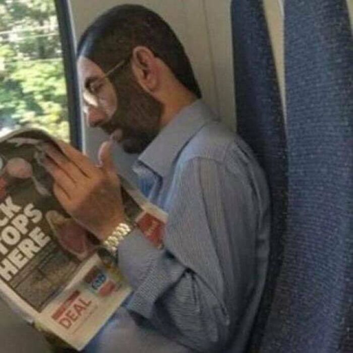Man with unusual face paint reading a newspaper on a train, featured in cursed pics and memes from an Instagram page.
