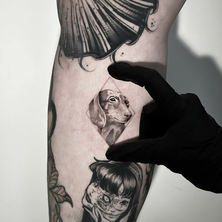 Single needle tattoo of a dog on someone's arm, highlighted against other tattoos.