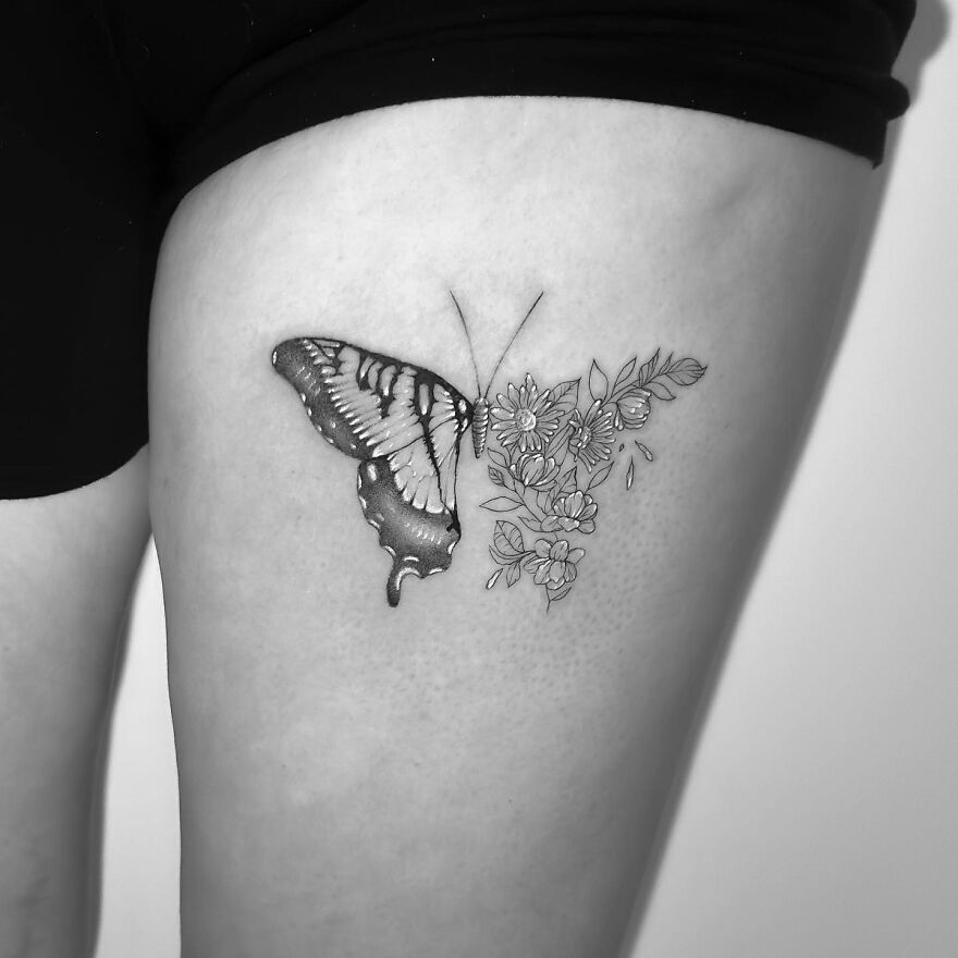 Single needle tattoo of butterfly and flowers on thigh.