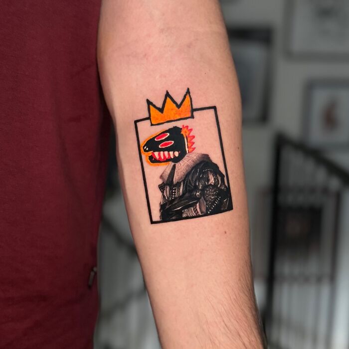 Tattoo merging two artistic styles with a modern figure and bright crown on an arm.