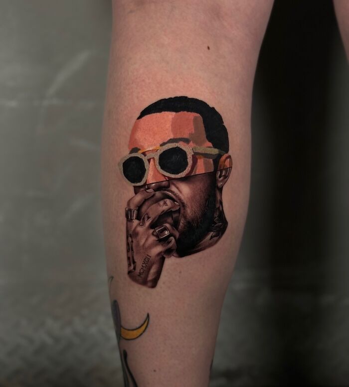 Tattoo on calf merging realism and abstract art styles, depicting a person with sunglasses and hand over mouth.