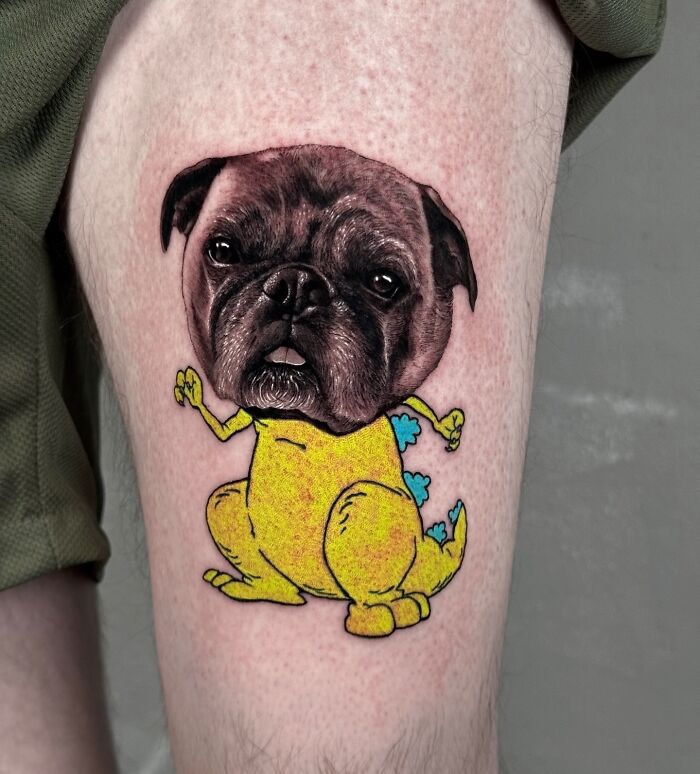 Tattoo combining a pug's realistic face with a cartoon dinosaur body, showcasing seamless artistic styles.