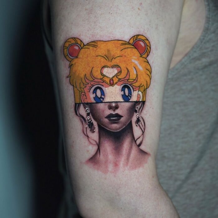 Tattoo merging anime and realism, depicting a character with colorful hair atop a monochrome portrait style.