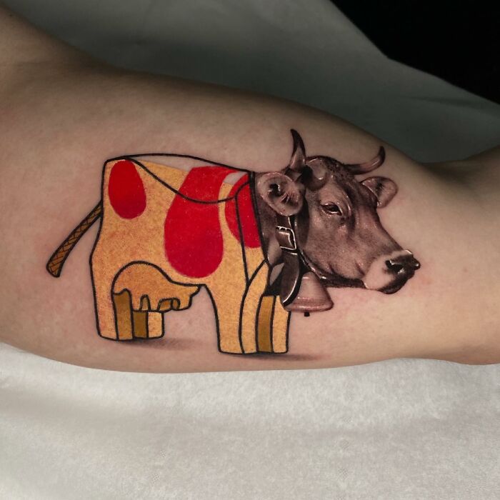 Tattoo merging two artistic styles: a cow with a geometric body and realistic head on an arm.