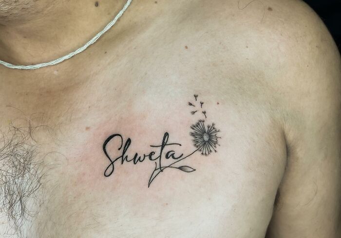 Chest tattoo with the name "Shweta" and a dandelion, representing uncomfortable tattoos created by artists.