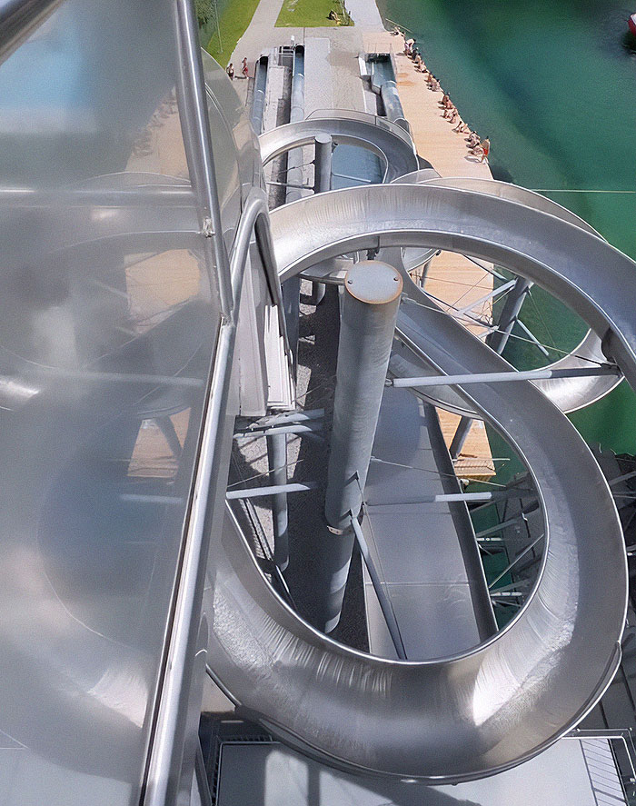 Extreme waterslide view from above, showcasing thrill-seeking diver's daring jump despite strict ban for women.
